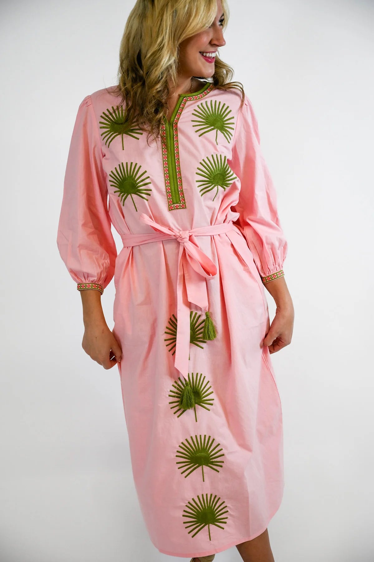 Victoria Dunn Quinn Dahlia pink midi dress with green embroidered palm leaf motifs, tassel belt tie, and three-quarter sle...