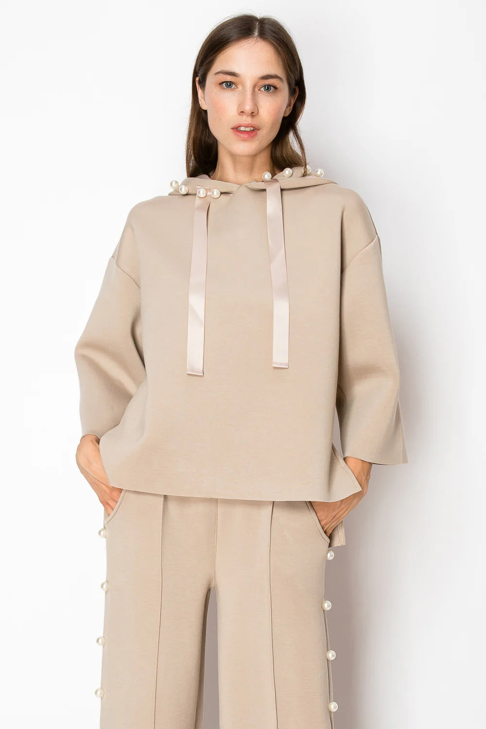 Joh Apparel Farrah French Scuba Pearl Pant in Taupe with wide-leg silhouette and decorative pearl embellishments along the...