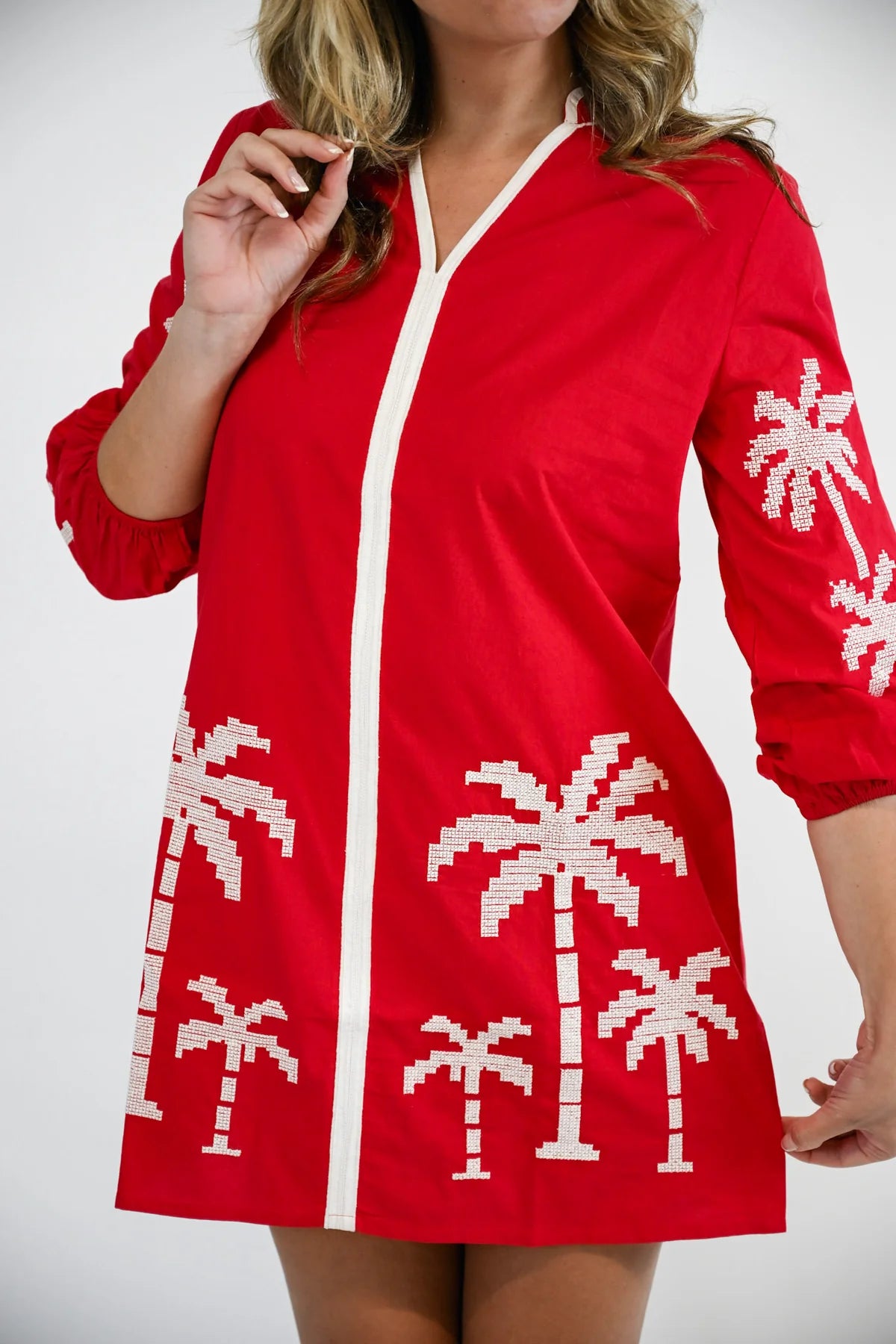 Victoria Dunn Presley red mini dress with white palm tree embroidery and V-neckline trim detail