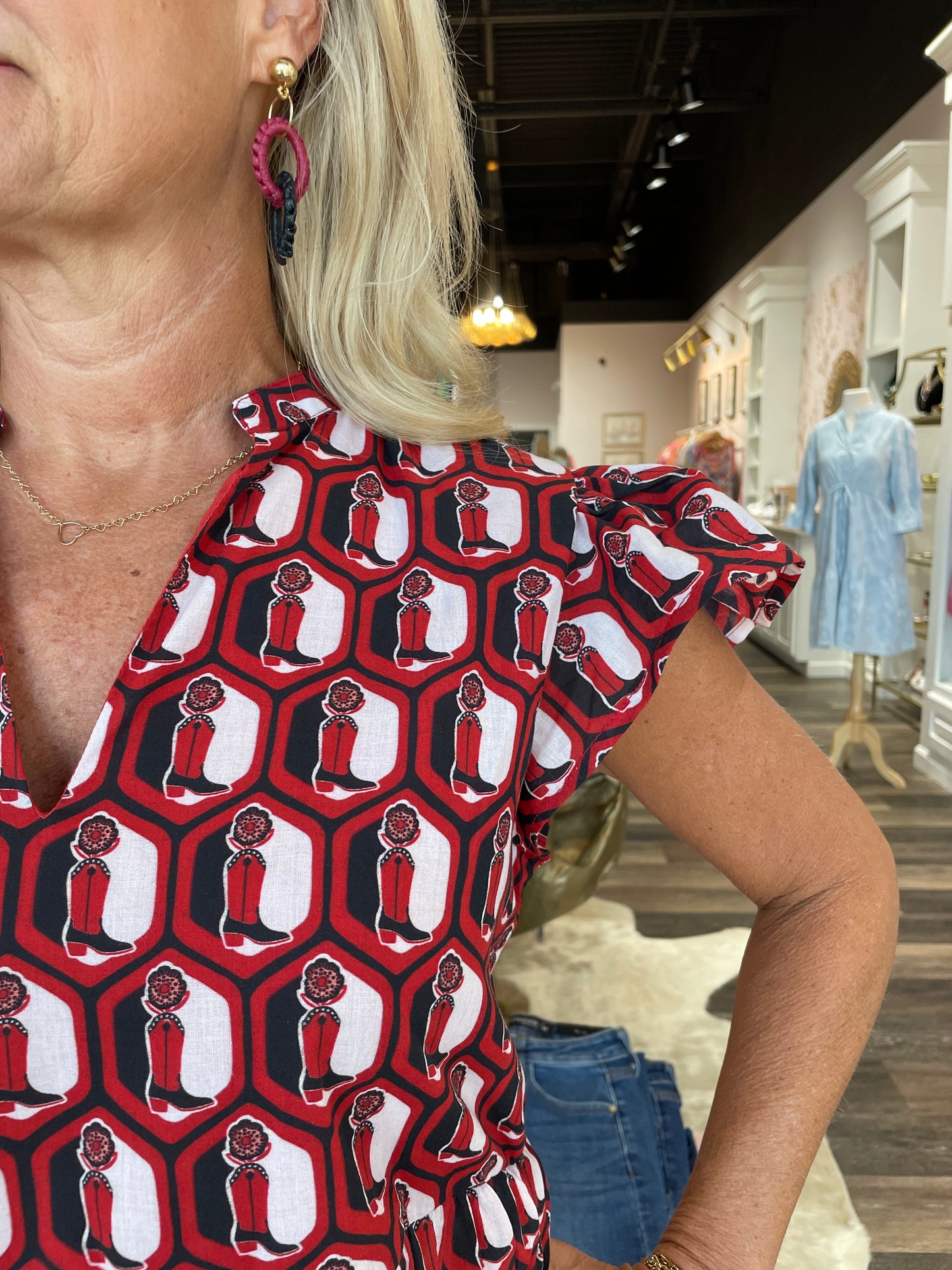 Briton Court Jenny flutter sleeve mini dress featuring a red, black, and white cowboy boot hexagon print pattern.