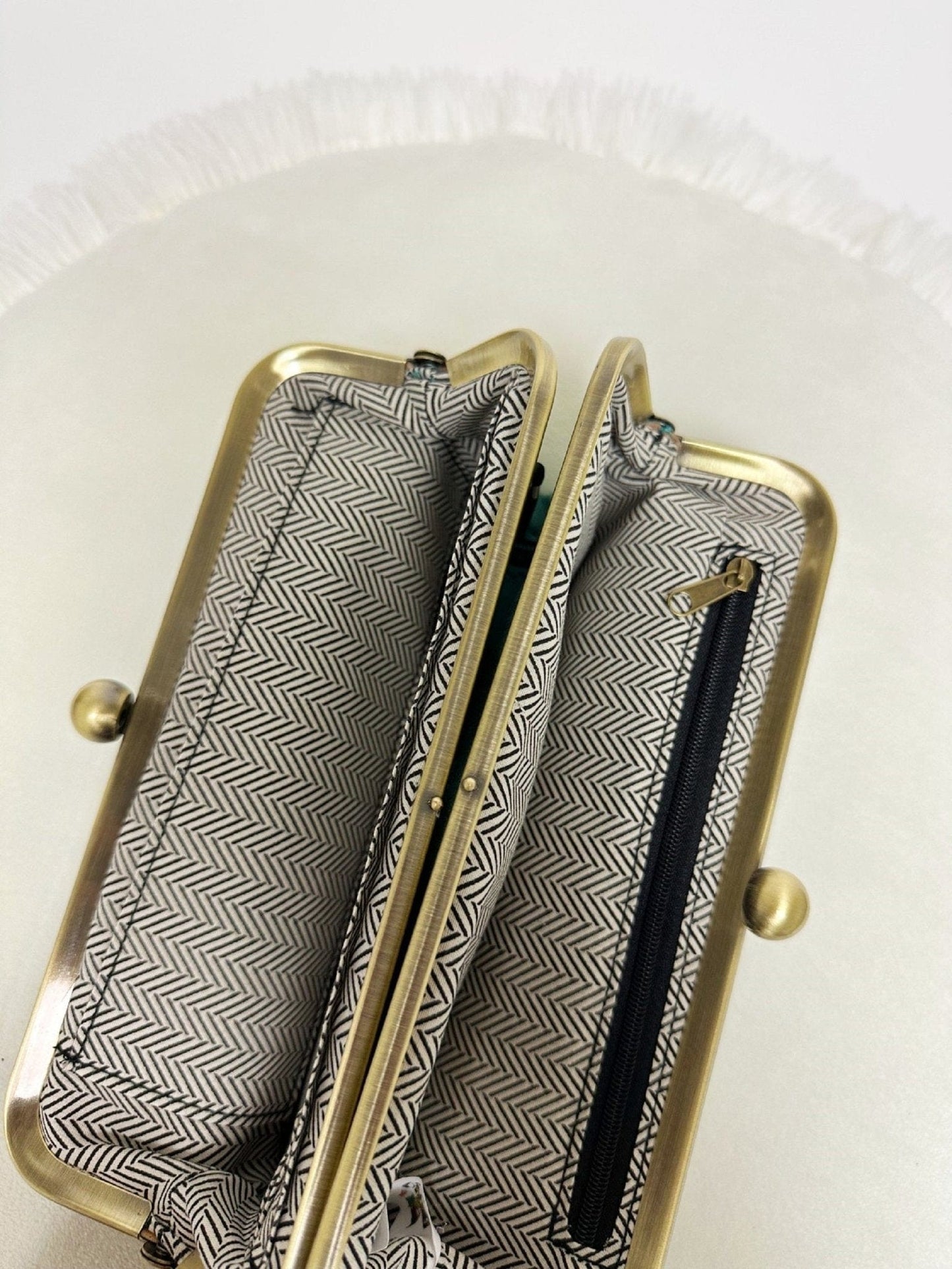 MiMi Wholesale Karen Kiss Lock Clutch BP208 interior view showing herringbone lining, gold frame, card slots, and zip pocket