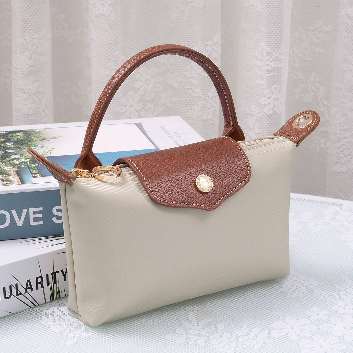 Penny Nylon Mini Crossbody Bag in Clay with brown leather flap closure and top handle.