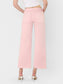 High Rise Crop wide leg bubblegum pink jeans with raw hem, back pockets, and white heel sandals.