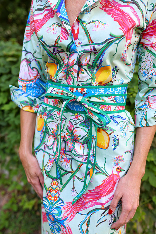 House of MBR Chinois Obi Belt in blue and green tied at waist over a colorful floral print dress, close-up styled view.