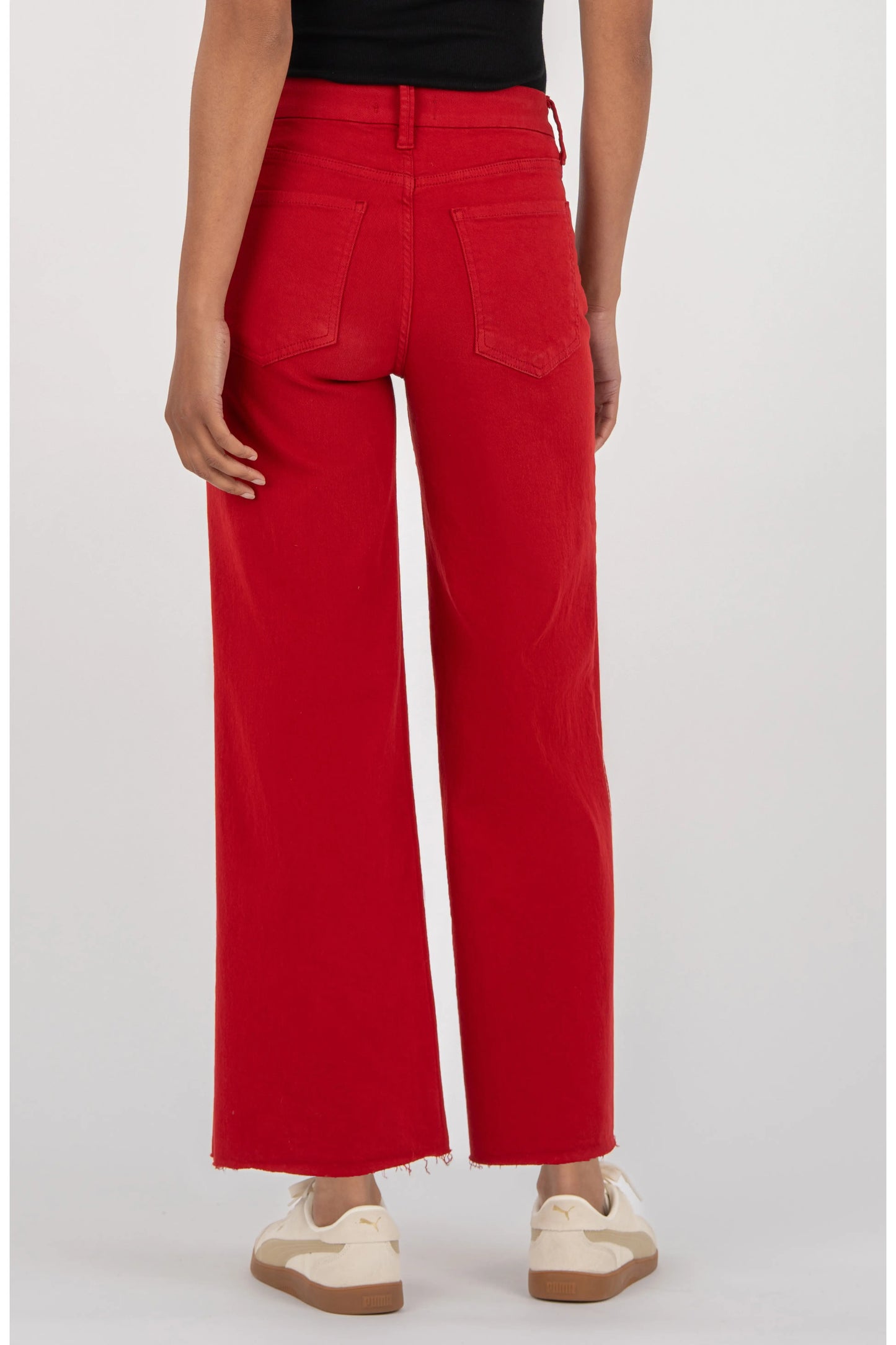 Kut Meg Fab Ab Wide Leg Jeans in Ruby Red — back view, high waist, raw hem, two back pockets, worn with white sneakers.