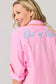 Vacay Out Of Office pink embroidered button-up cover-up shirt with turquoise script lettering on back.