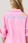 Vacay Out Of Office pink oversized cover-up shirt with turquoise embroidered script and beach umbrella embroidery on back.