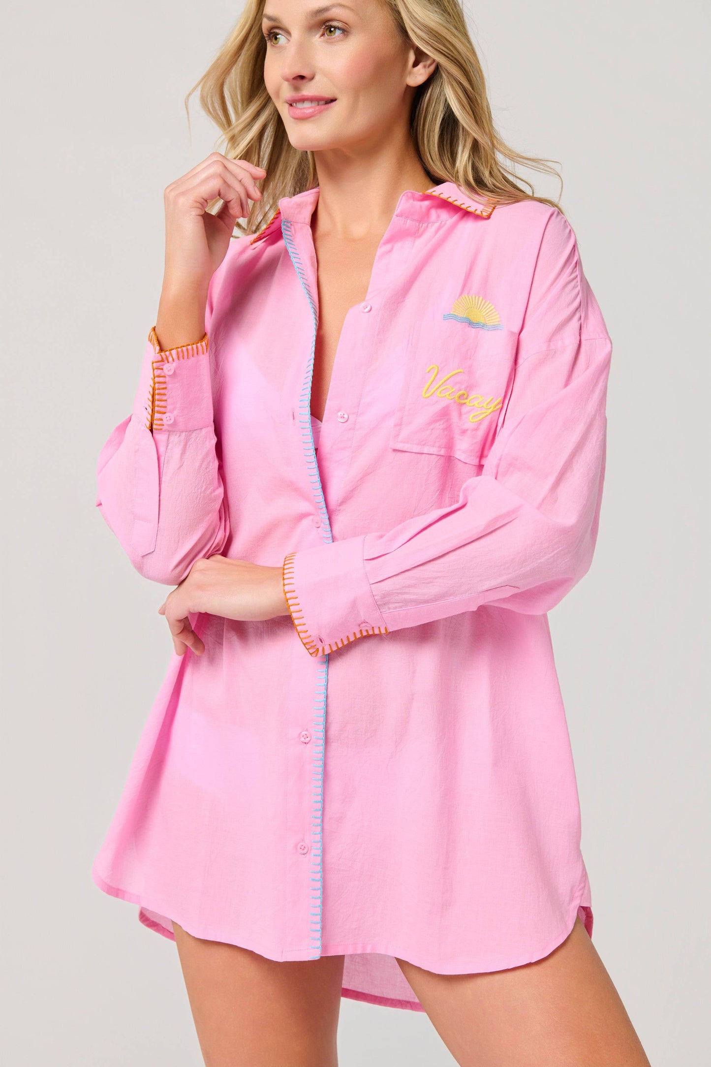 Vacay Out Of Office pink button-down oversized cover-up shirt with sun embroidery and colorful contrast stitching detailing.