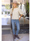 The Willow Bloom scalloped-hem textured knit top with puff sleeves, styled with skinny jeans and ankle boots.