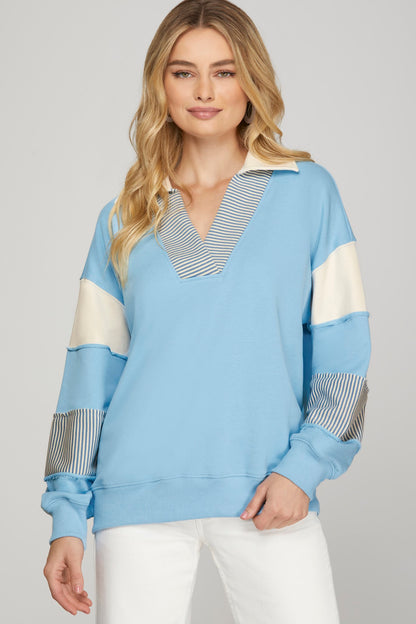 SHE+SKY Color Block French Terry Sweatshirt in sky blue with cream panels, striped collar V-neck, and patchwork sleeves, front view.