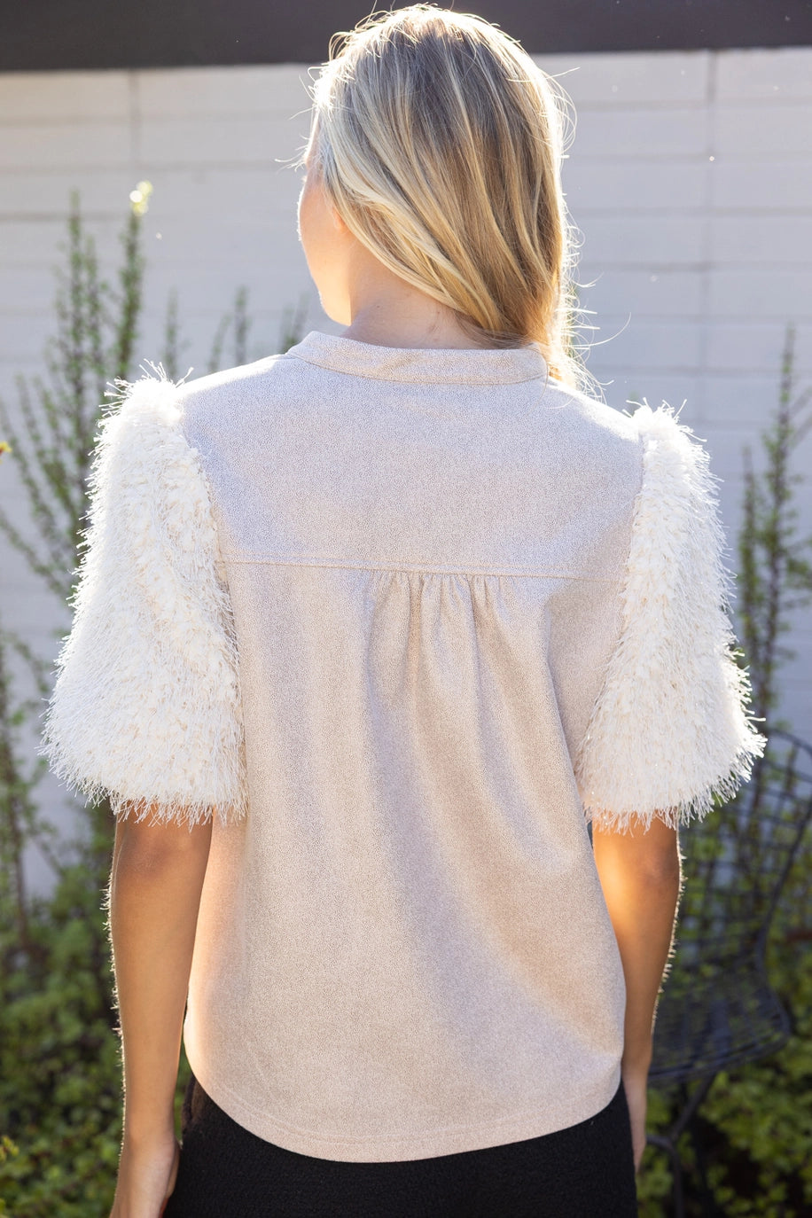 The Faux Feather Top Cream back view showcasing fluffy feather-textured puff sleeves and relaxed woven body.