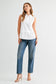 Caroline sleeveless white collared button-front top styled with blue straight-leg jeans and nude heeled sandals.
