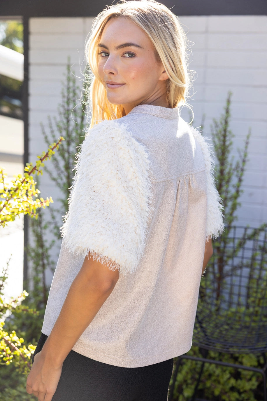 The Faux Feather Top Cream by The Faux Feather, featuring textured feathery sleeves and a smooth woven back.