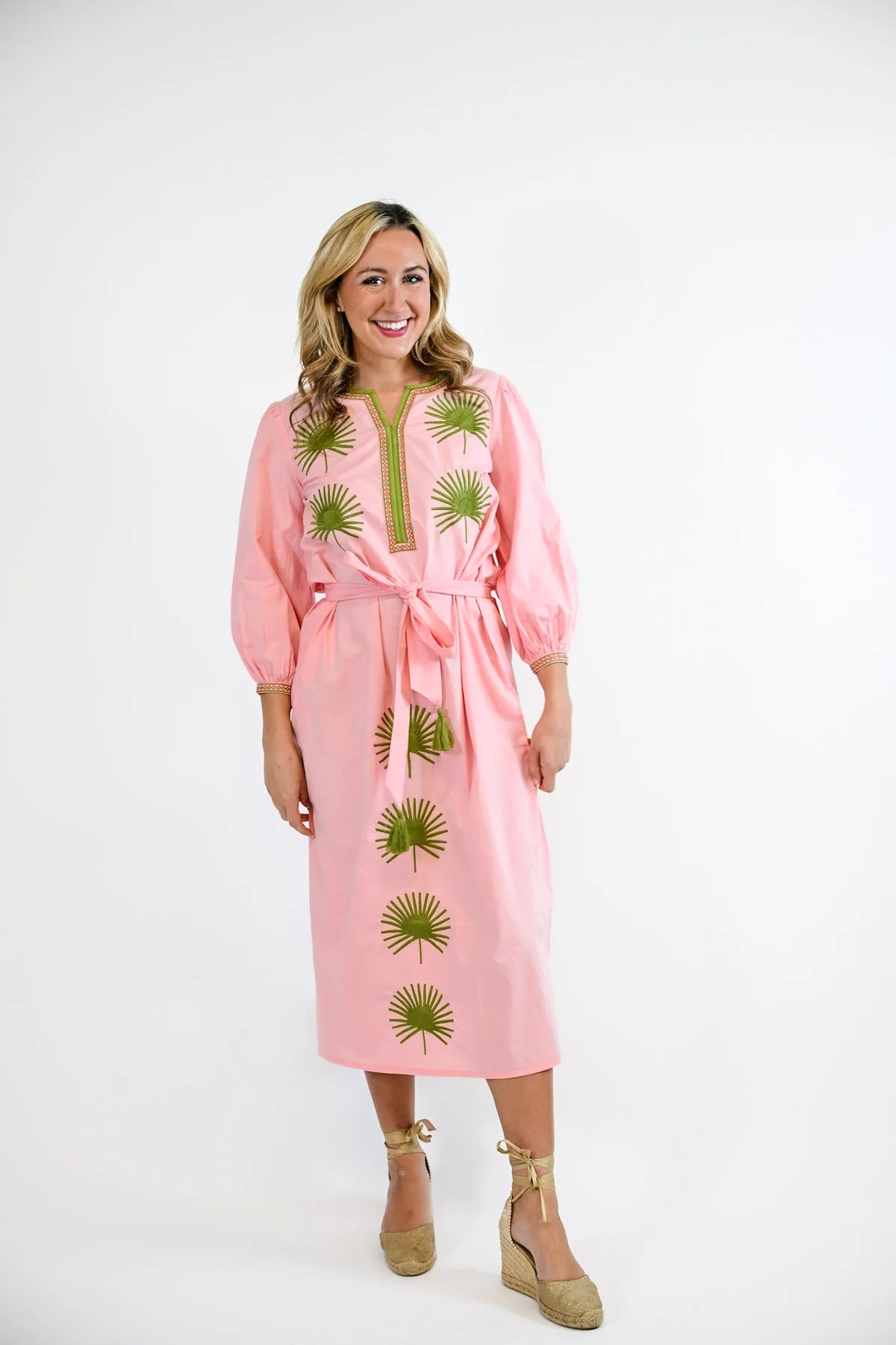 Victoria Dunn Quinn Dahlia pink midi dress with green embroidered palm leaf motifs, puff sleeves, and tie waist.