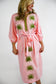 Victoria Dunn Quinn Dahlia pink midi dress with green embroidered palm leaf motifs, tassel belt tie, and three-quarter sle...