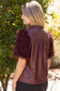 The Faux Feather Top Burgundy by The Faux Feather, featuring faux leather body with fluffy feather-textured short sleeves.