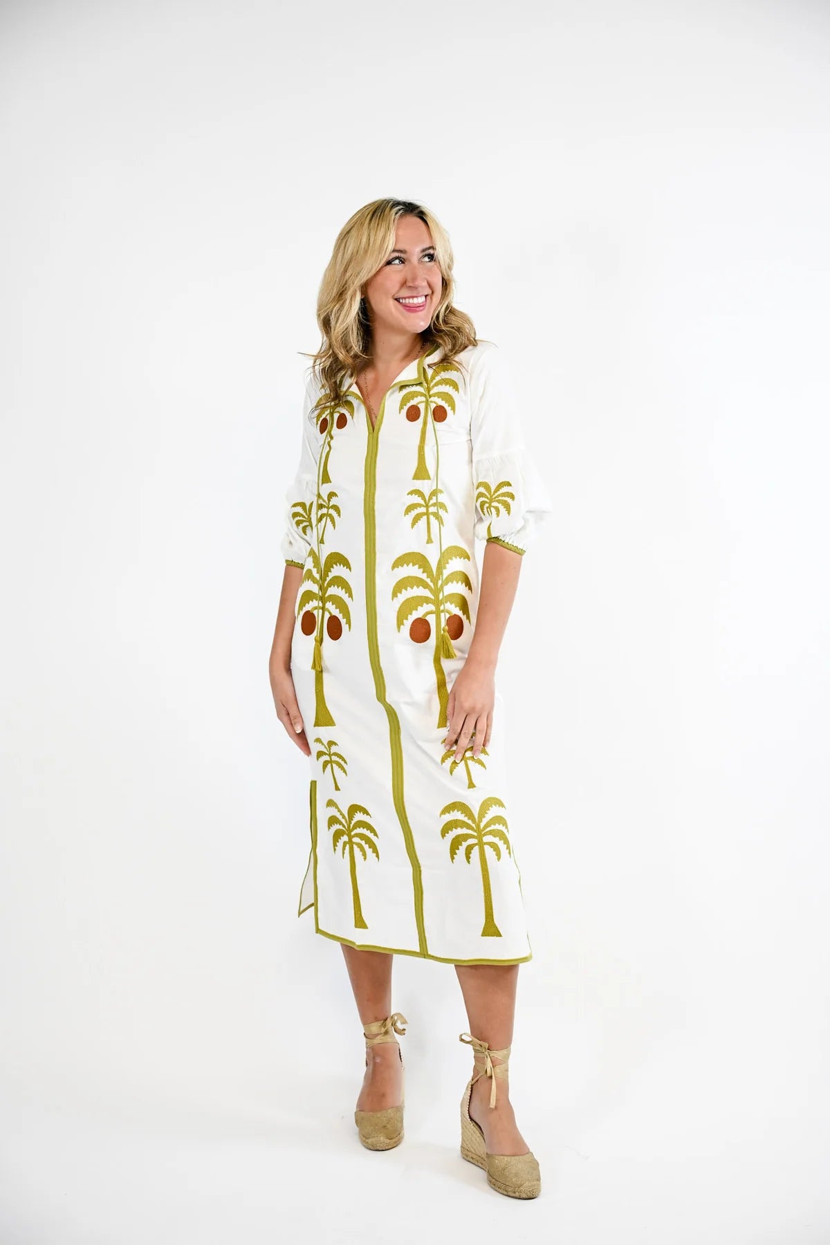 Victoria Dunn Esme white midi dress with green palm tree embroidery, worn with espadrille wedges.