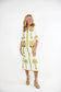 Victoria Dunn Esme white midi dress with green palm tree embroidery, worn with espadrille wedges.