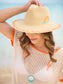 Sunrise Sun Hat straw fedora with embroidered sunset motif, zigzag orange trim, and wide brim.