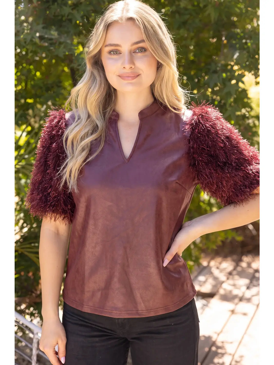 The Faux Feather Top Burgundy by The Faux Feather, featuring a faux leather body with fluffy feather-textured short sleeve...