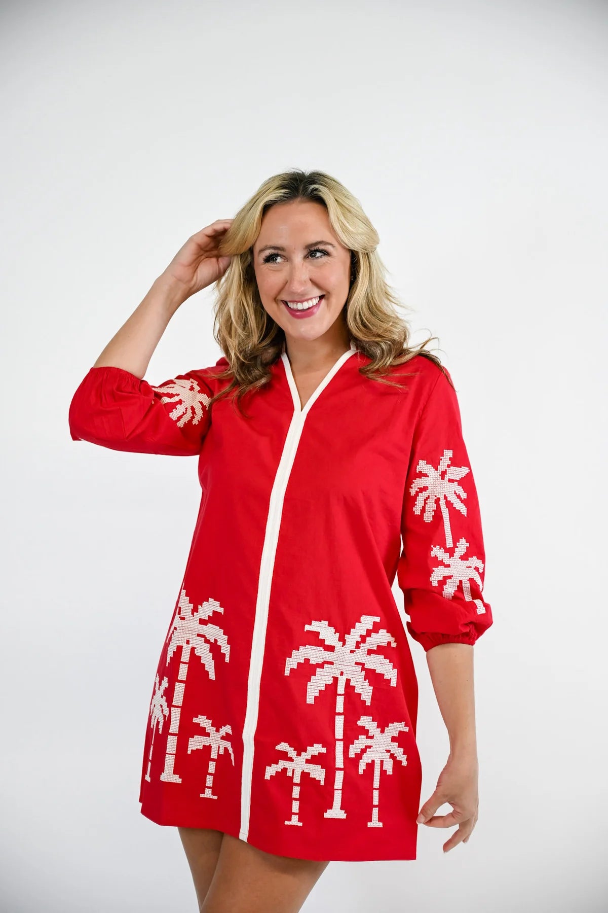 Victoria Dunn Presley red mini shirt dress with white embroidered palm tree print and three-quarter sleeves.