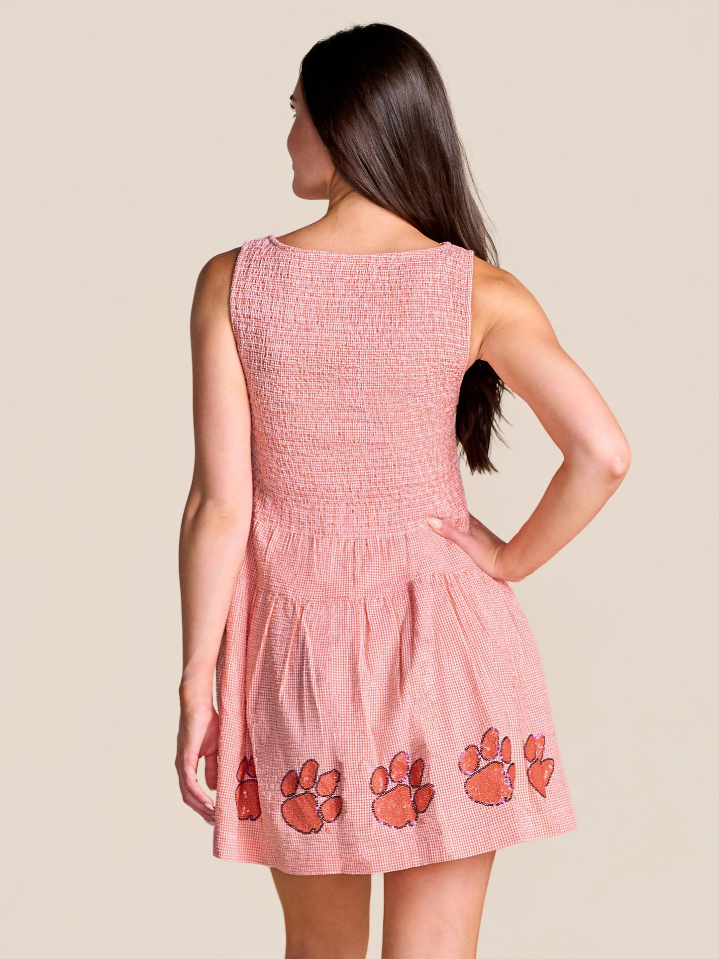 Stewart Simmons Good Sport Seersucker Dress Clemson, back view, orange gingham smocked bodice with sequin tiger paw appliqués on hem.