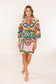 House of MBR Venice Obi Belt worn by model over a colorful abstract-print mini dress with green, red, and blue tones.