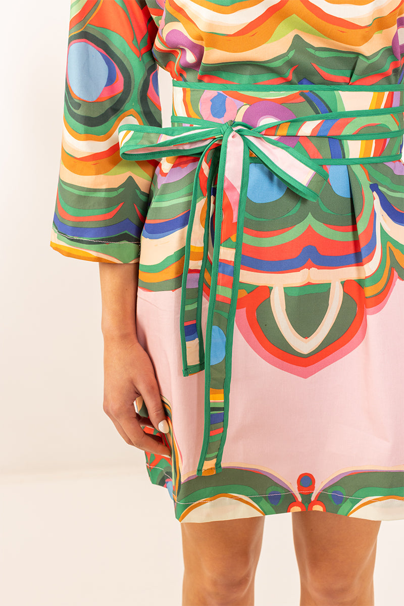 House of MBR Venice Obi Belt in multicolor geometric print with green trim, tied at waist over matching dress, close-up view.