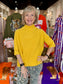 Maple Mockneck Sweater in mustard yellow, featuring ribbed turtleneck collar and elbow-length sleeves.