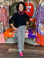 Maple Mockneck Sweater in black with ribbed flutter sleeves, styled with gingham pants and pink sneakers.