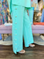 Joh Apparel Farrah French Scuba wide-leg mint pants featuring decorative pearl button side seam detail.