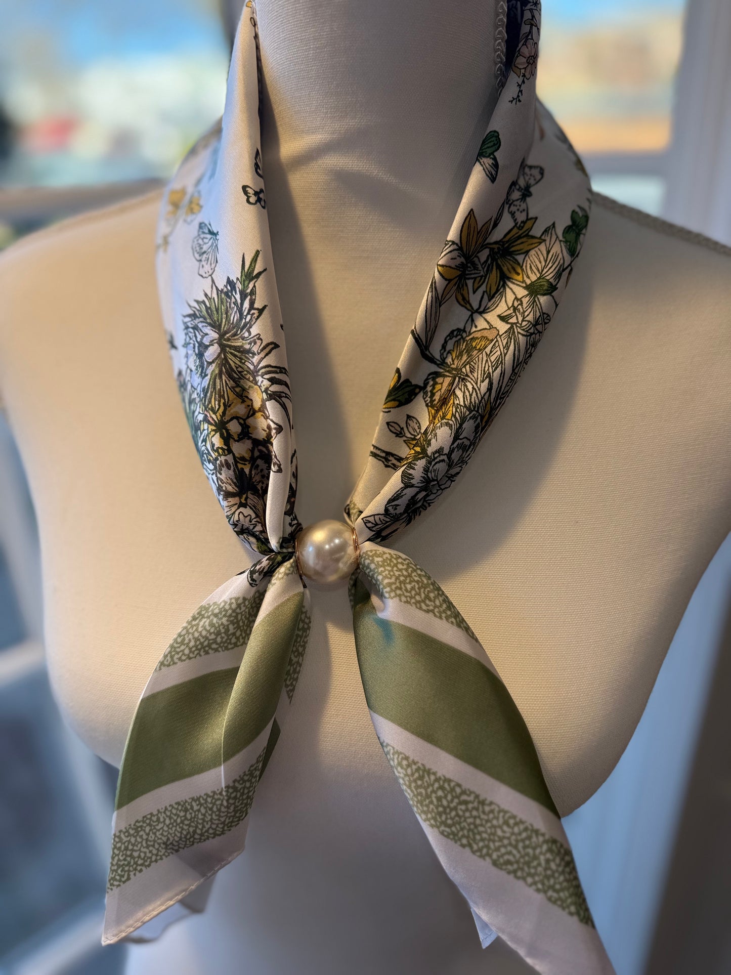 Ready To Wear magnetic scarf with floral print and pearl ring clasp displayed on mannequin neck.