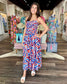 Printed Tiered Maxi Dress featuring bold geometric swirl pattern, smocked bodice, spaghetti straps, and flowing skirt.