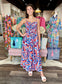 Printed Tiered Maxi Dress featuring bold geometric print, ruched bodice, spaghetti straps, and flowy tiered skirt.