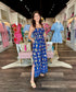 Joy Joy Tuscan cinched waist maxi dress with vibrant tile print, side slit, and smocked bodice.