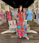 Briton Court Strawberry Waves Charlie Maxi Dress featuring red and turquoise floral bird print with ruffle hem and mock neck.
