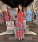 Briton Court Strawberry Waves Charlie Maxi Dress featuring bold floral print, mock neckline, and tiered ruffle hem.