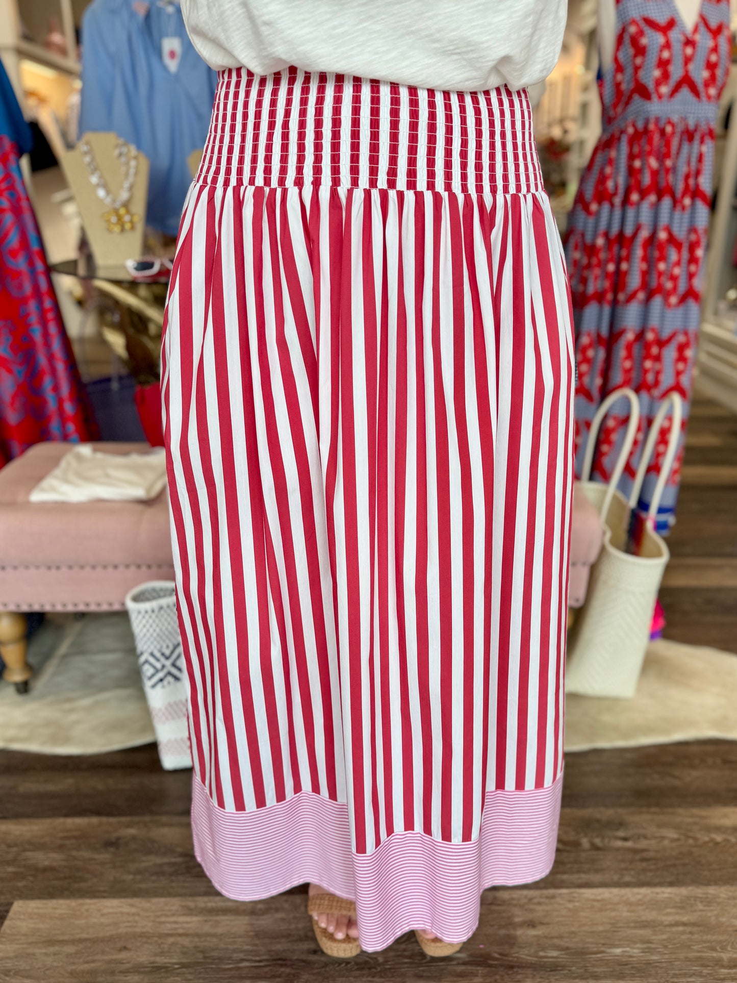 Caryn Lawn Sutton Stripe Skirt Red — back view, red and white vertical stripes, smocked waistband, pink micro-stripe hem band.