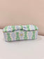 Mary Square Kiss & Makeup Mini rectangular cosmetic bag with blue and green floral print and bow zipper pull.