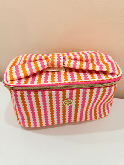 Mary Square Kiss rectangular makeup bag with pink and orange wavy stripe pattern and gold zipper closure.