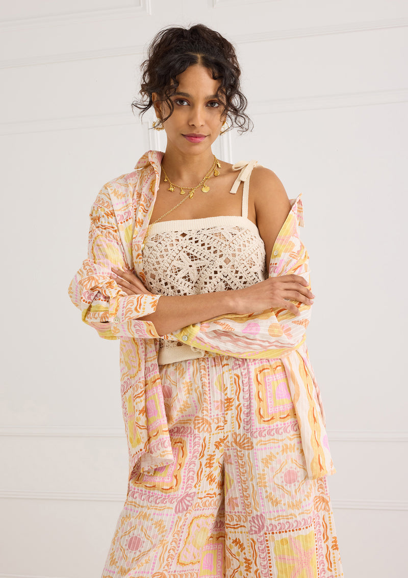 Alivia Kendra Top Seastar Crochet in cream, worn by model with patterned shirt and wide-leg pants, front view.