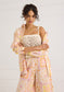 Alivia Kendra Top Seastar Crochet in cream, worn by model with patterned shirt and wide-leg pants, front view.