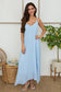 The Bella Breeza Linen Maxi Dress in light blue with spaghetti straps and flowy silhouette.