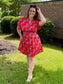 Maude Vivante Yana Dress in red fan print, featuring short sleeves, V-neckline, and fitted waist silhouette.