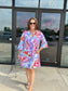 Jude Connally Kerry dress featuring bold butterfly mosaic print, bell sleeves, and V-neckline, worn by smiling woman outdo...