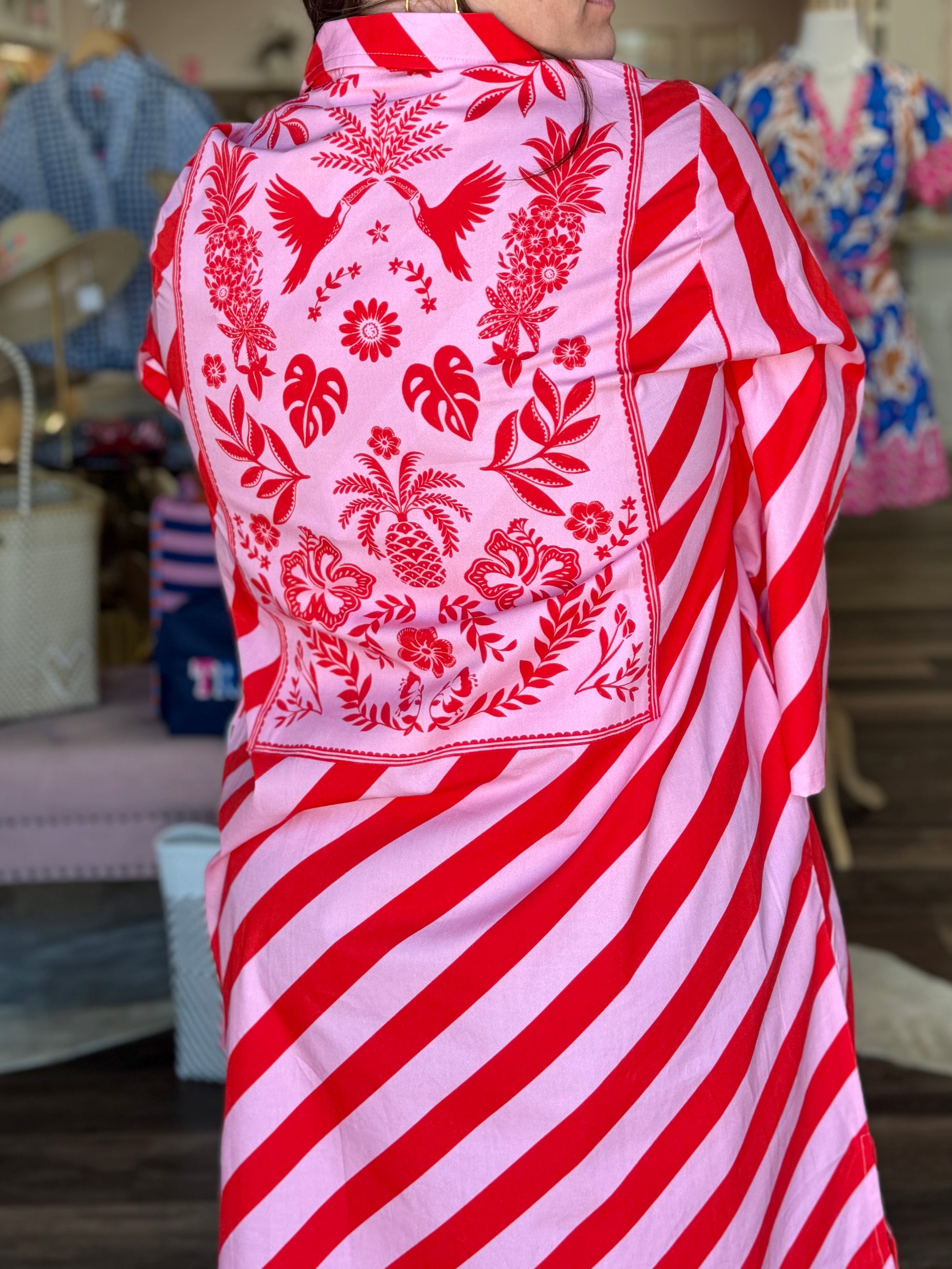 Maude Vivante Sophia Scarlet Slash Dress featuring diagonal red and pink stripes with a tropical floral bandana-print back...