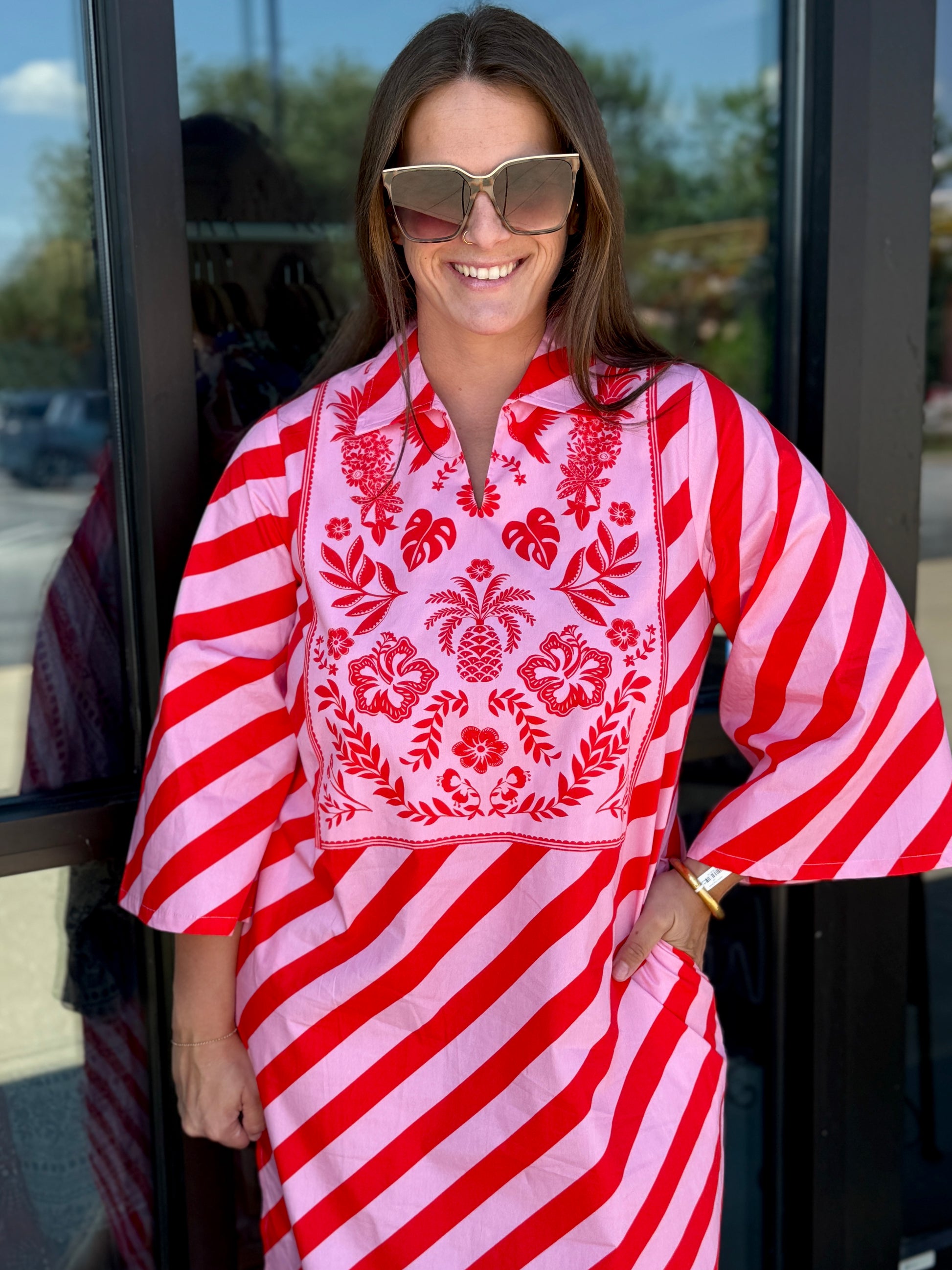 Maude Vivante Sophia Scarlet Slash Dress featuring red and pink diagonal stripes with tropical embroidered bib neckline.
