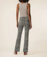 Kut Kelsey High Rise Ankle Flare jeans in gray leopard print, back view on model paired with a beige tank top.