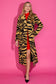Alden Adair Darby Coat Noir Cat — long tiger-print coat with black and gold pattern, worn over a red dress.