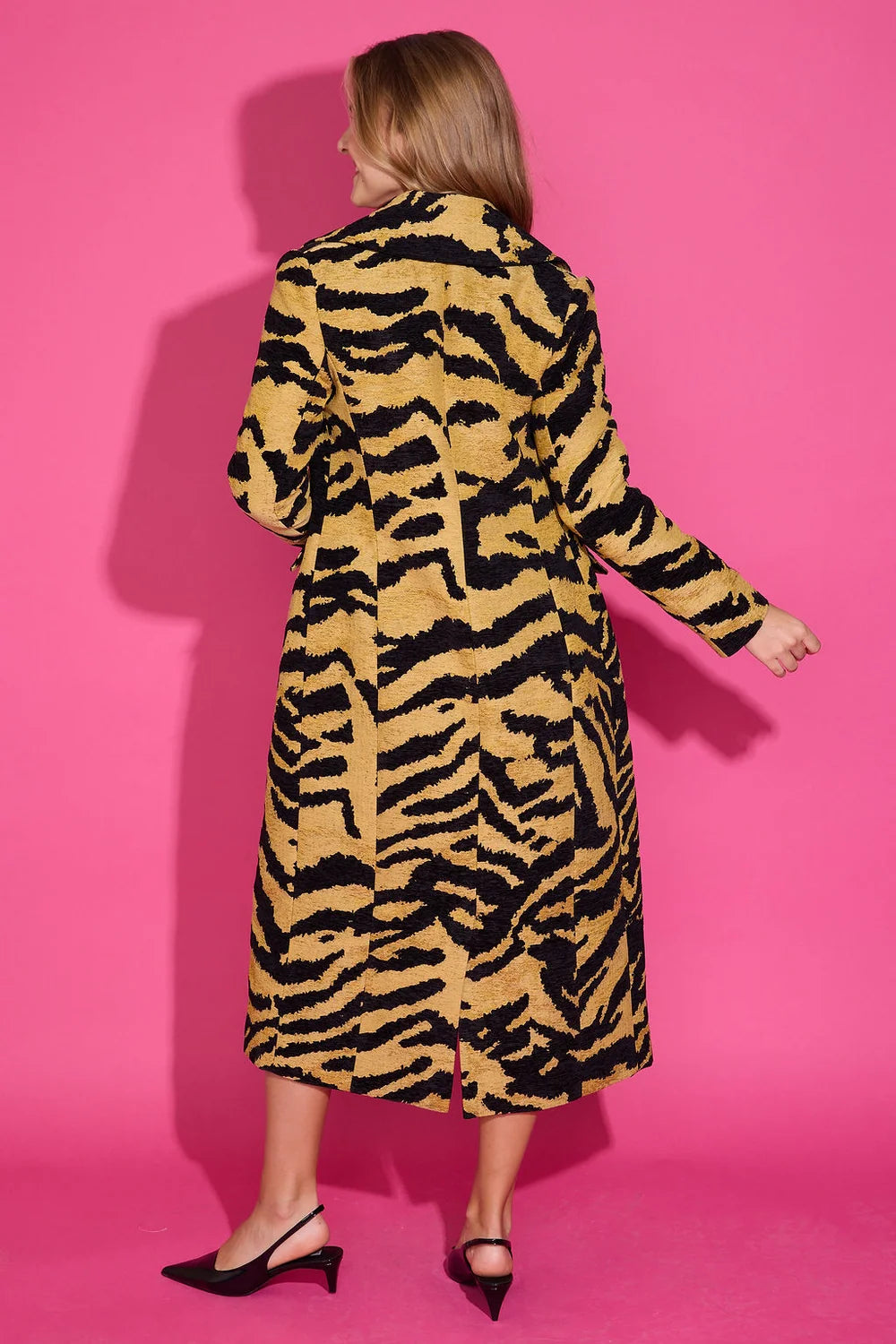 Alden Adair Darby long tiger-print coat with black and gold pattern, shown from the back.